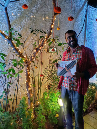 Prashant Miranda receiving the first printed copy of The Ants and The Pen