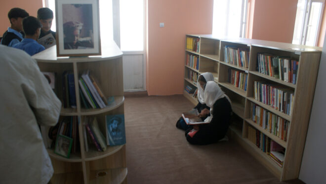 Girls reading on the floor of Afghan library