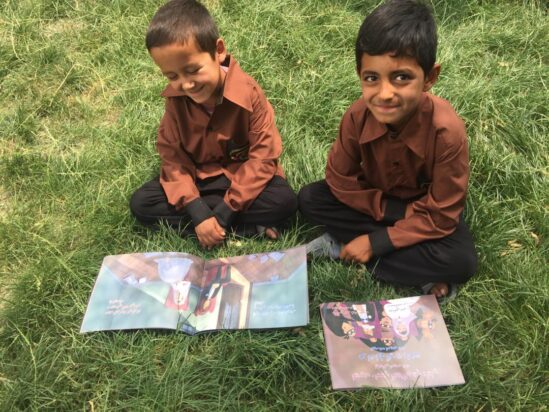 Children at the orphanage receiving ISF books